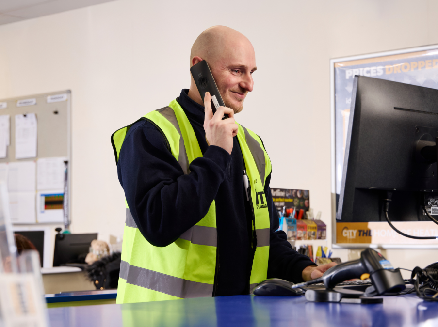 City Plumbing Employee in a branch on the phone